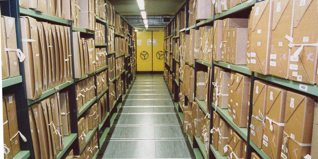 row of boxes on stacked shelves