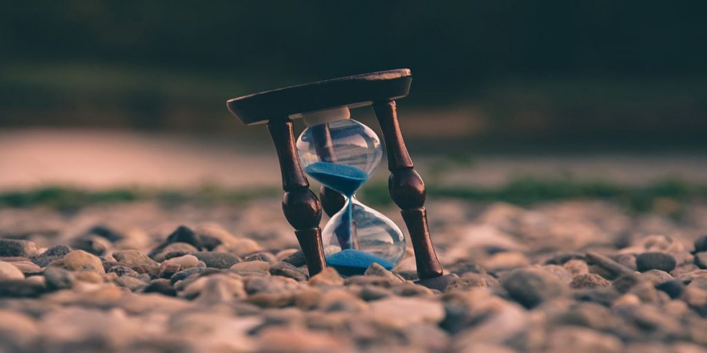 photo of an hourglass in a bed of rocks