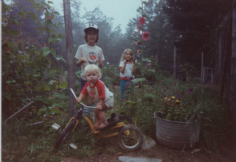 photo of three children in a garden