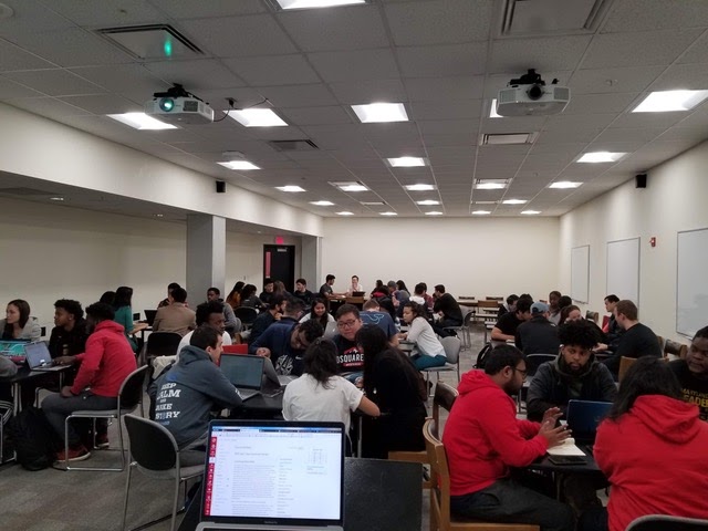 room filled with people sitting around tables