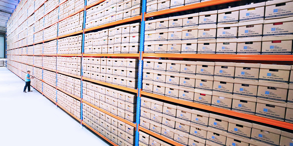 Stacks of archival documents in organized boxes.