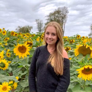 photo of Claire Morville in a sunflower field