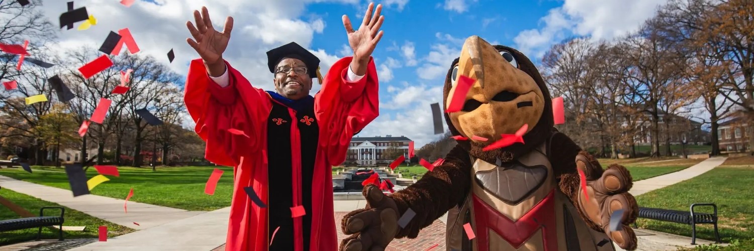 Photo of Darryll Pines and Testudo throwing confetti