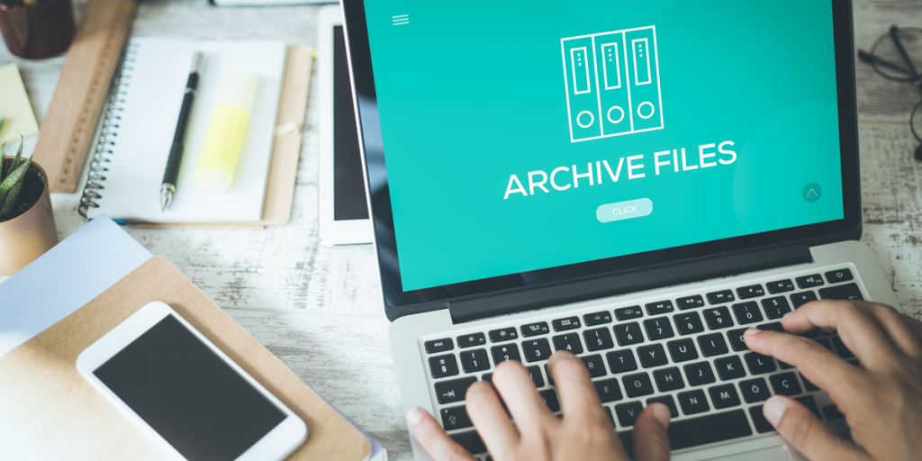 hands show on top of a laptop keyboard with a screen that reads "archive files"