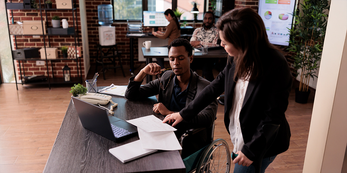 People with disabilities working together in a professional office setting.