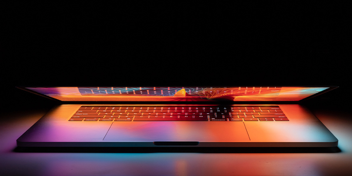 Image of half closed laptop with glowing red screen.