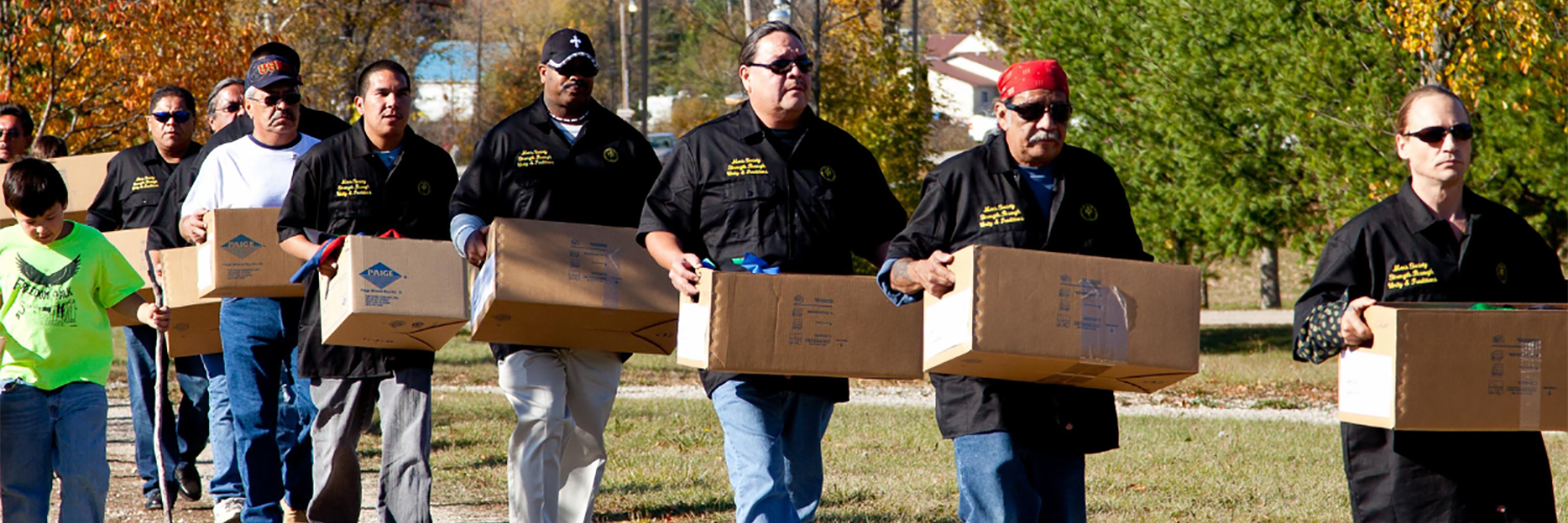 People walking with boxes of archival materials