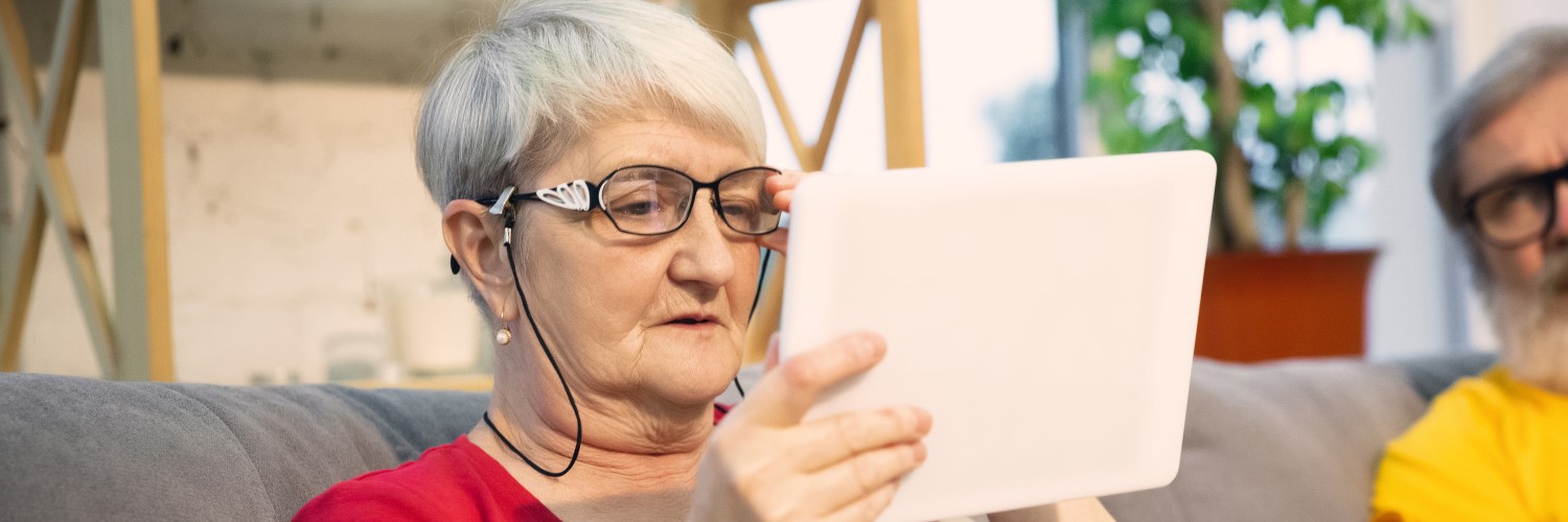 Photo of a senior woman looking at a tablet