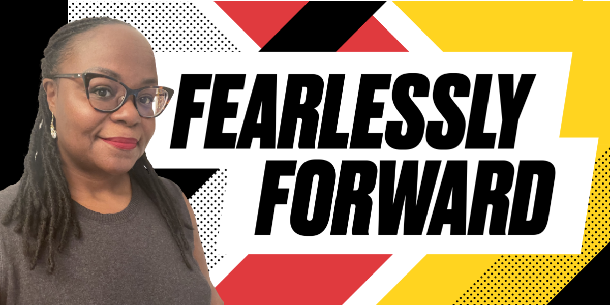 Photo of Sheri Massey in front of a UMD Fearlessly Forward Banner