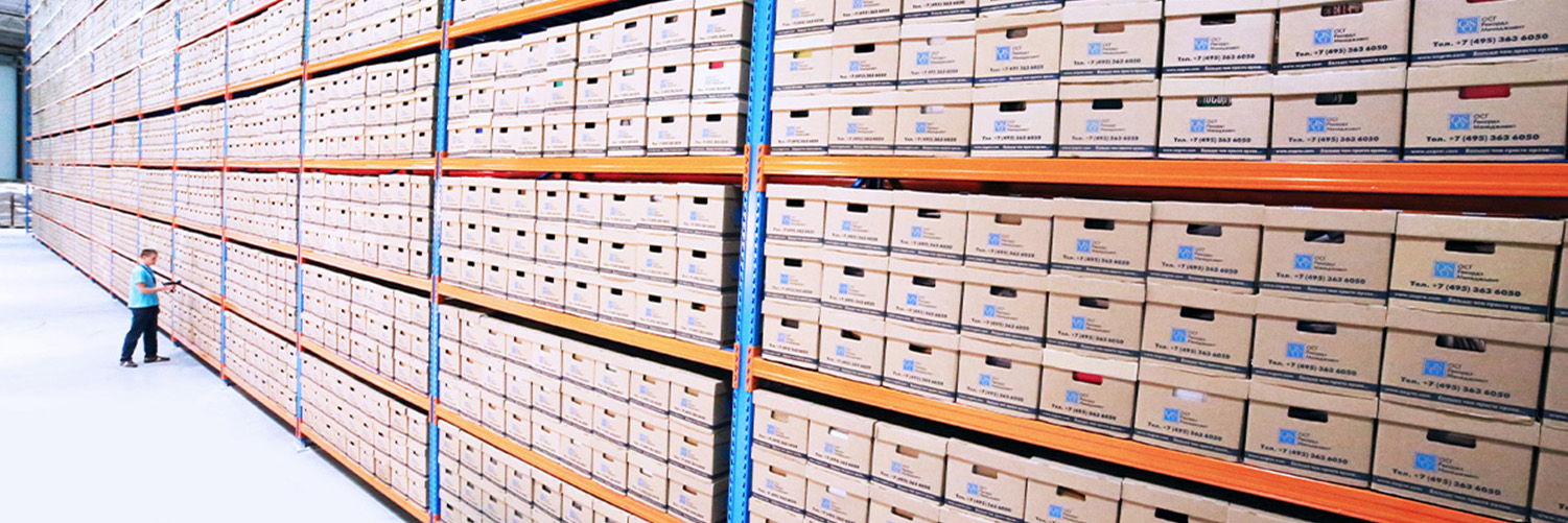 A large aisle containing boxes of archives on shelves