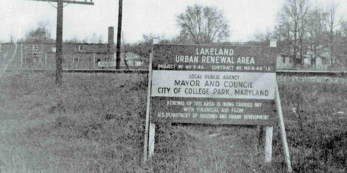 Black and white photo of a sign in Lakeland community around the 1970s that says "Urban Renewal Area"