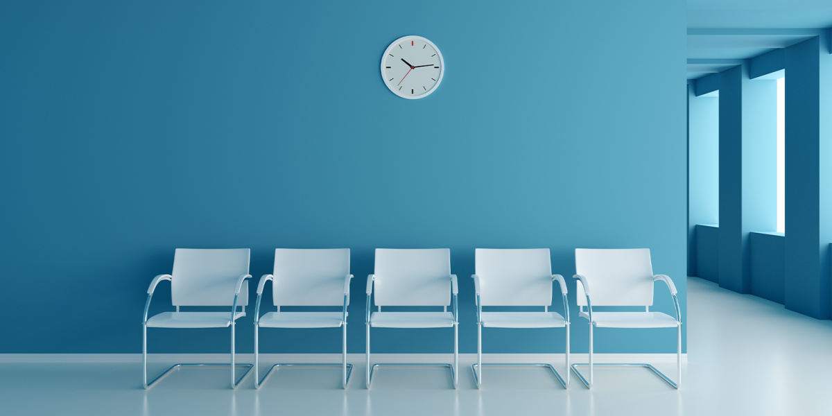 Waiting room space on blue corridor with large windows in clinic