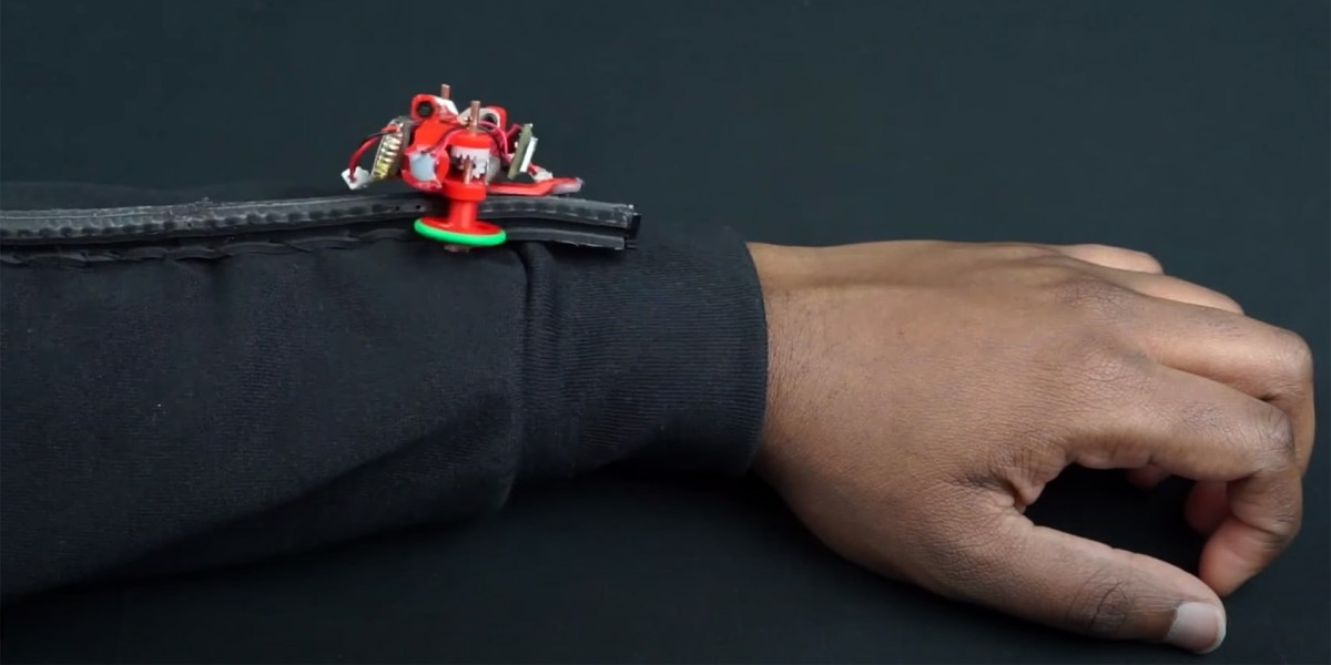 Close up photo of the mini robot on a person's arm.