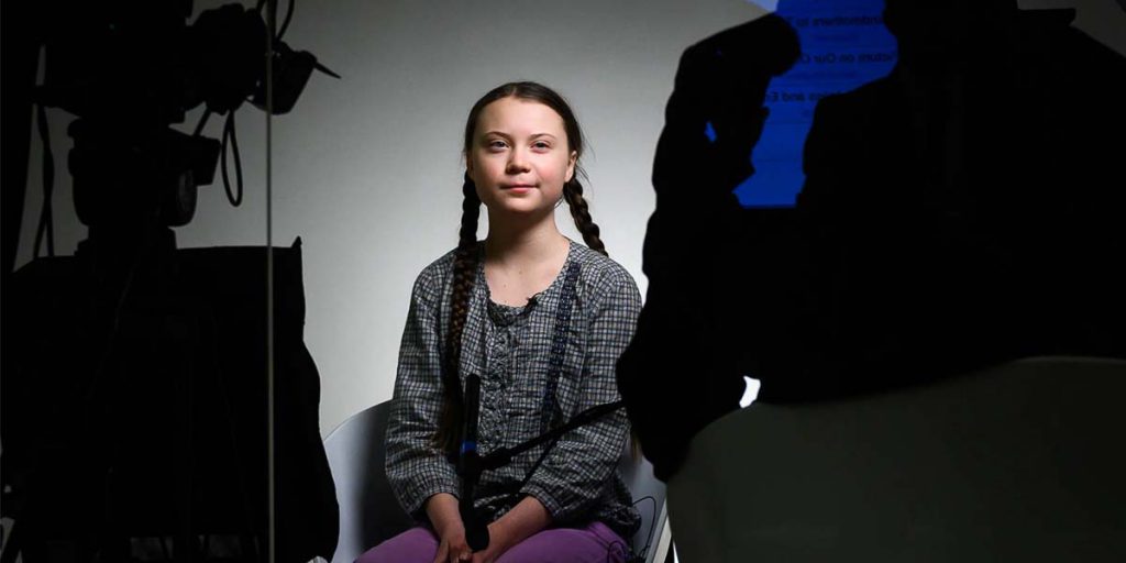 Greta Thunberg sitting in a chair