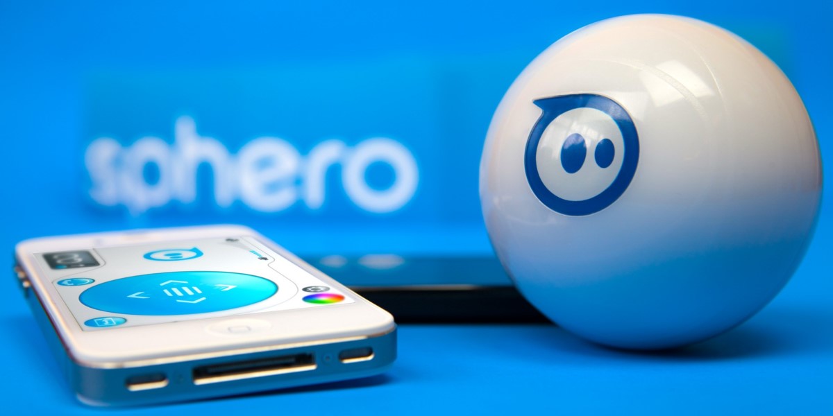 Photo of Sphero an opaque white ball with an iPhone to it's left