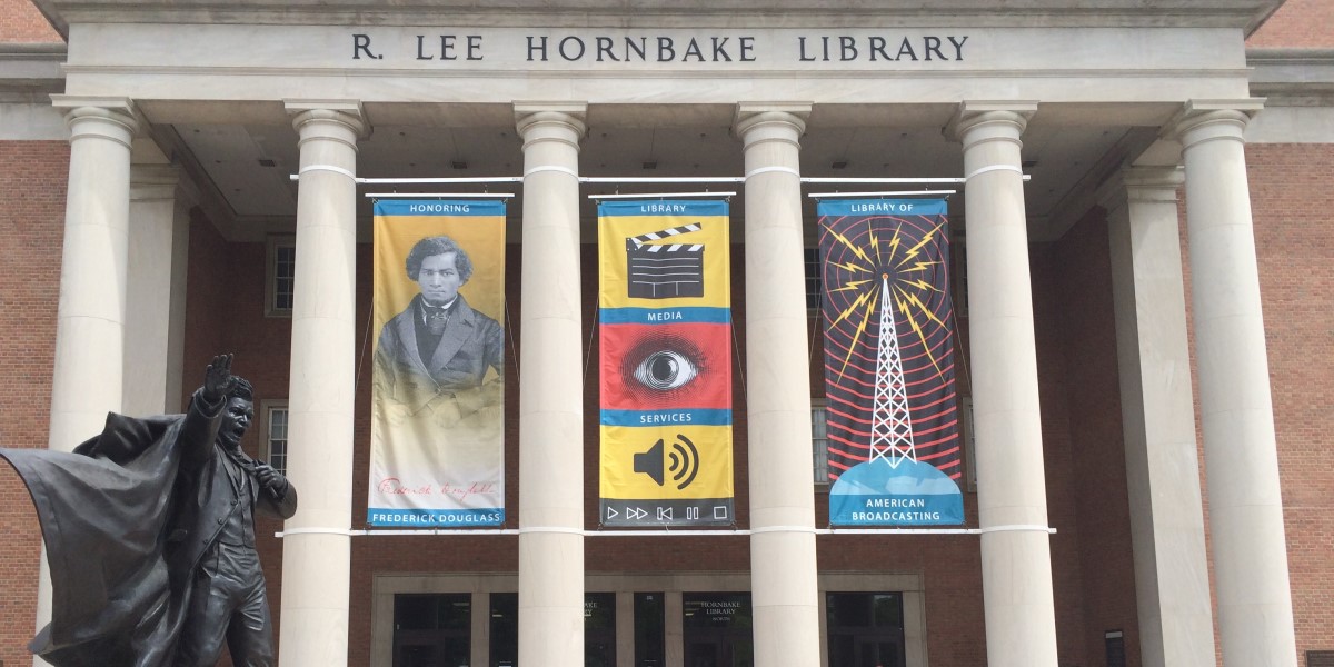Photo of UMD's Hornbake Library with a Statue of Frederick Douglass in Front