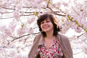 Photo of Bailey DeSimone in front of cherry blossoms