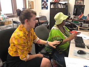 Student working with woman on computer