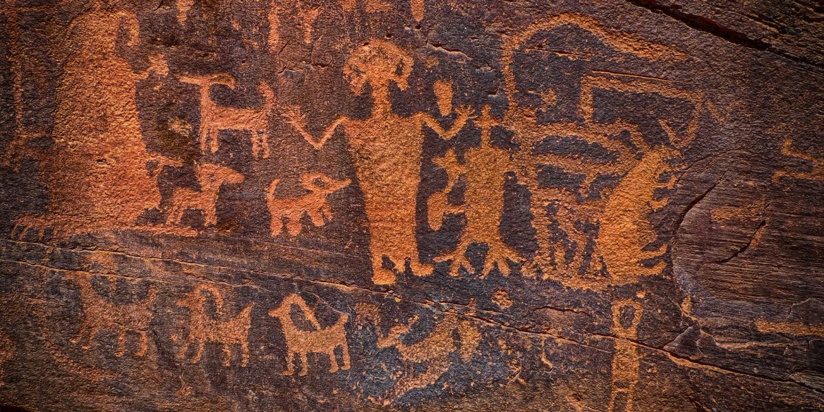 Image of people and animals carved into a rock