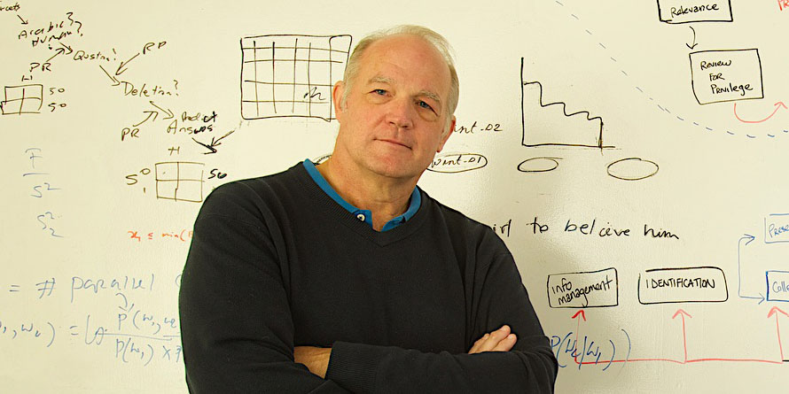 Headshot of Douglas Oard in front of a whiteboard