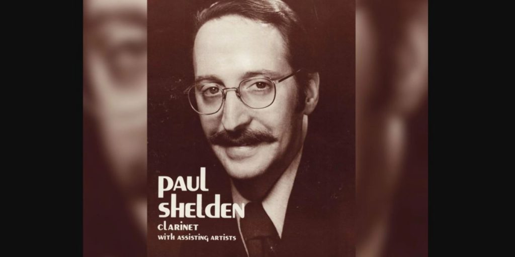 headshot of ​Dr. Paul Shelden with the words "​Paul Shelden clarinet with assisting artists" on top in white