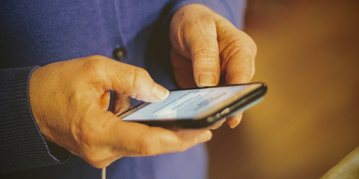 Image of hands holding cell phone