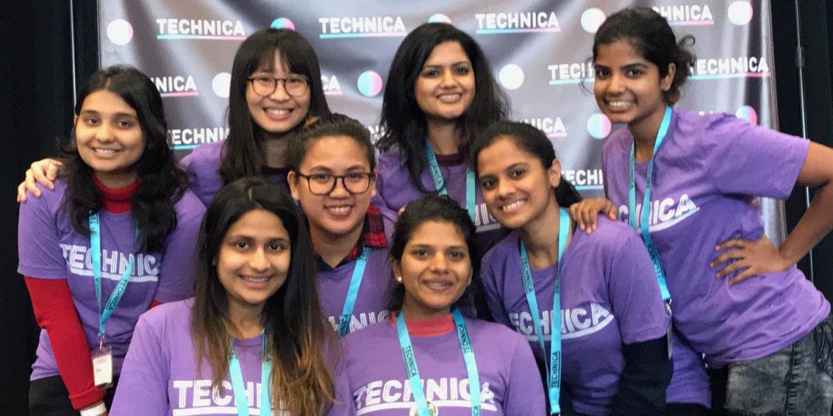 photo of people in matching purple shirts smiling