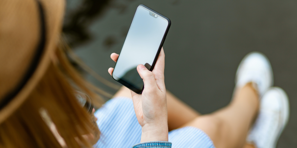 Photo of a woman looking at her smart phone